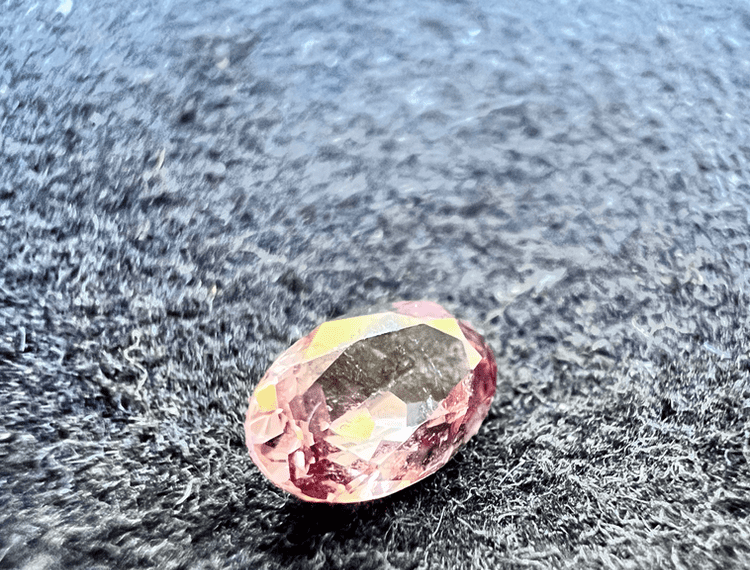 pink elbaite tourmaline stone cut on a neutral background to illustrate the tourmaline