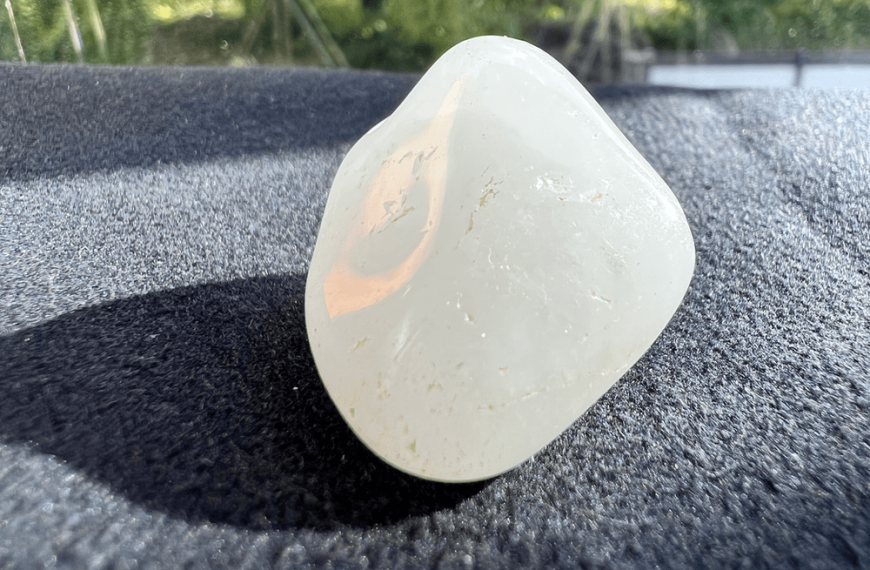 milky quartz or white snow quartz in rough stone on a neutral background to illustrate snow quartz or milky quartz