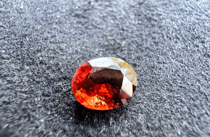 garnet stone hessonite orange red cut stone on neutral background to illustrate garnet