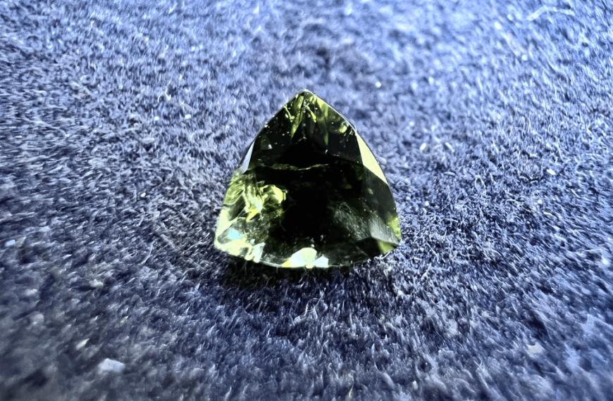 dravite green stone on a neutral background to illustrate a green stone