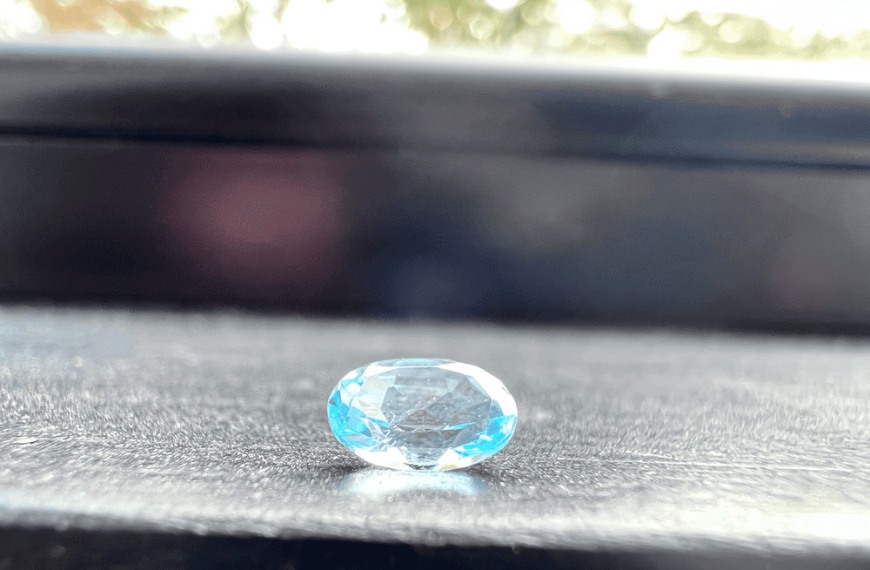 treated blue topaz stone cut on a neutral background to illustrate imitations of the