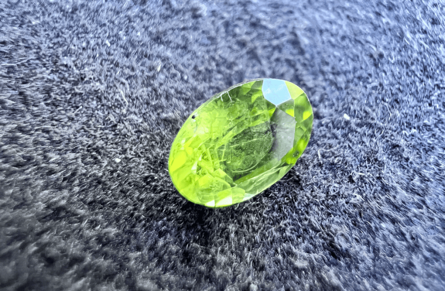peridot green stone on a neutral background to illustrate a green stone