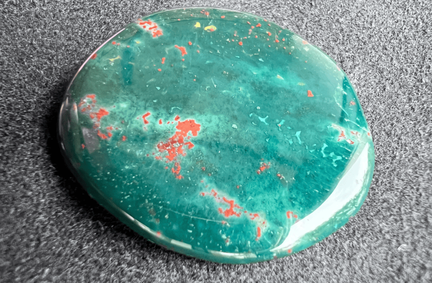green heliotrope or blood jasper with red spots on a neutral background to illustrate a green gemstone