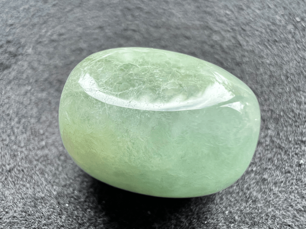 jade jadeite green stone on neutral background to illustrate a green stone