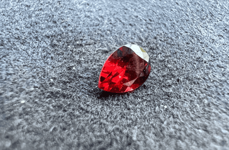 red almandine garnet stone cut on neutral background to illustrate almandine garnet