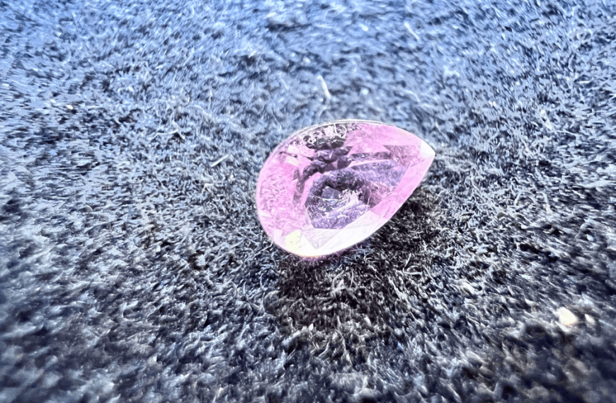 pink elbaite tourmaline stone cut on a neutral background to illustrate the tourmaline