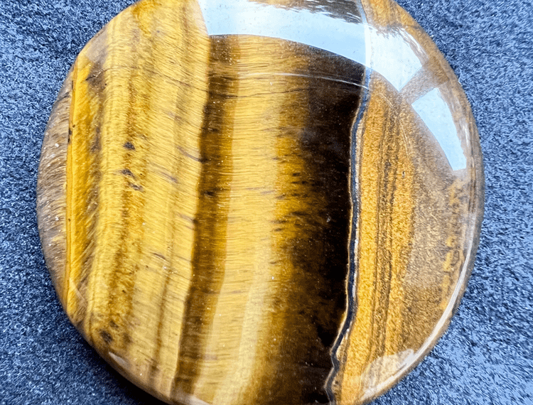 yellow and brown tiger's eye flat stone to illustrate a yellow stone